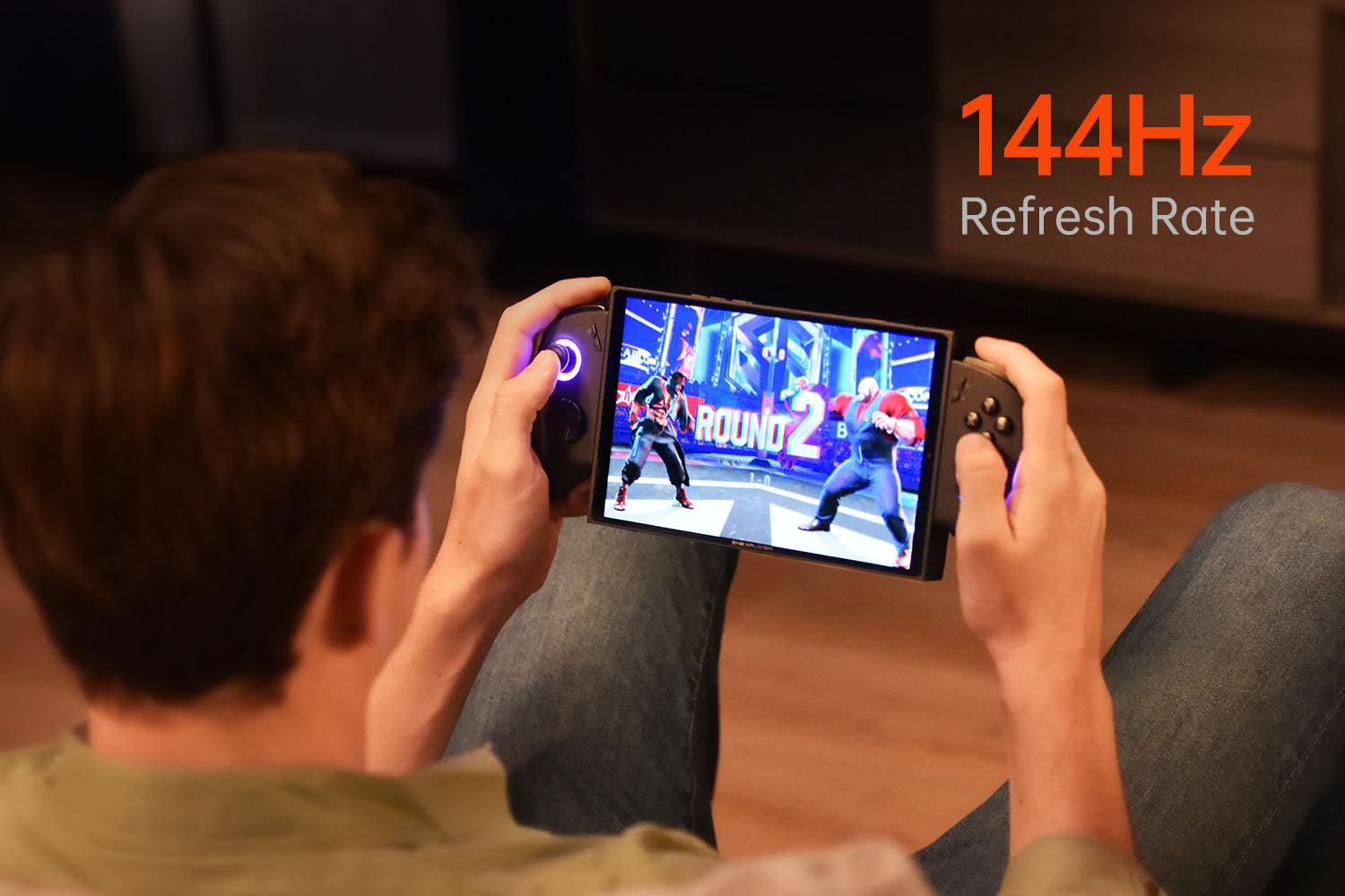 ONEXPLAYER X1 Mini 4 A person playing a fighting game on the ONEXPLAYER X1 Mini in handheld mode, showcasing the device's ergonomic controls and smooth gameplay supported by a 144Hz refresh rate.