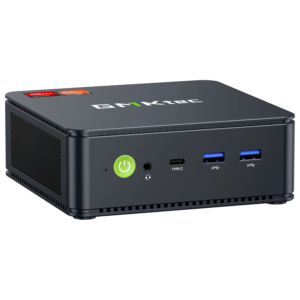 The image shows the GMKTEC NUBOX M5 Mini PC, a sleek and compact computing device. It has a modern design with a matte black finish. The front panel features several connectivity ports, including USB ports and an audio jack, and the GMKTEC logo is prominently displayed on the top. The overall design is minimalist, emphasizing portability and functionality for diverse computing tasks.